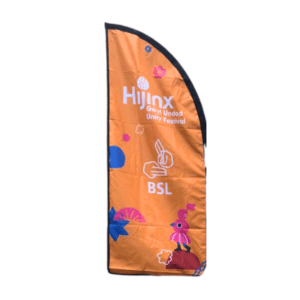 The flag indicating BSL. It is orange, long and narrow, with the Hijinx logo and a BSL icon on it, as well as some of the Unity Festival illustration branding.