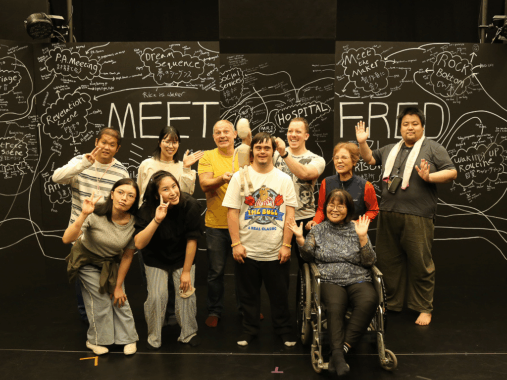 The workshop participants at Bird Theatre Festival smiling and posing with Ben, Gareth, Nick and Fred against the blackboard Meet Fred set.