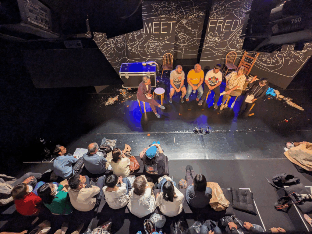 A birds-eye-view of an audience watching the post-show Q&A.