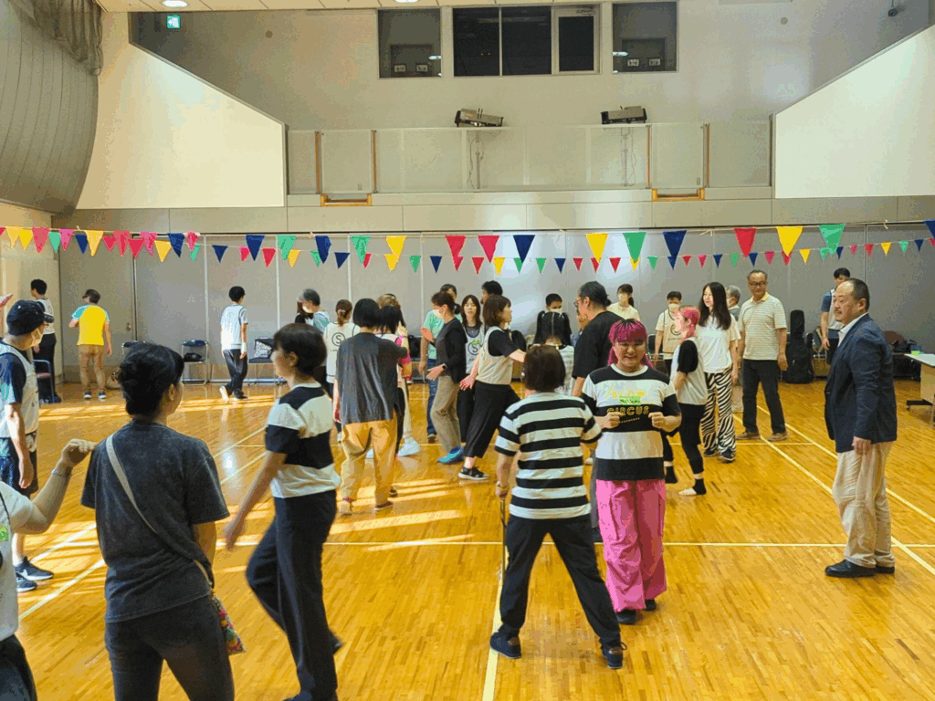 About 30 people interacting in a big open space during a workshop. 