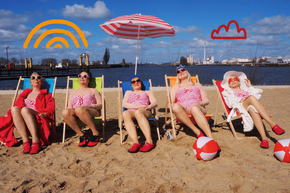 http://Five%20women%20in%20red%20and%20white%20stripey%20swimming%20costumes%20sitting%20on%20deckchairs%20on%20a%20sandy%20beach.